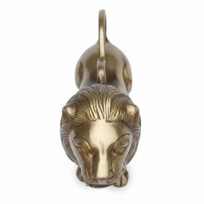 Brass lion head sculpture on a white background