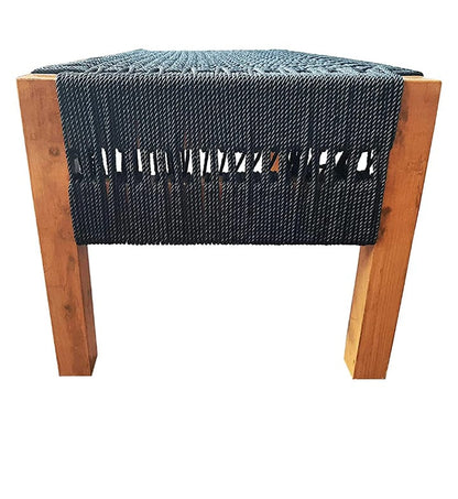 Wooden stool with a woven blue cushion on a white background