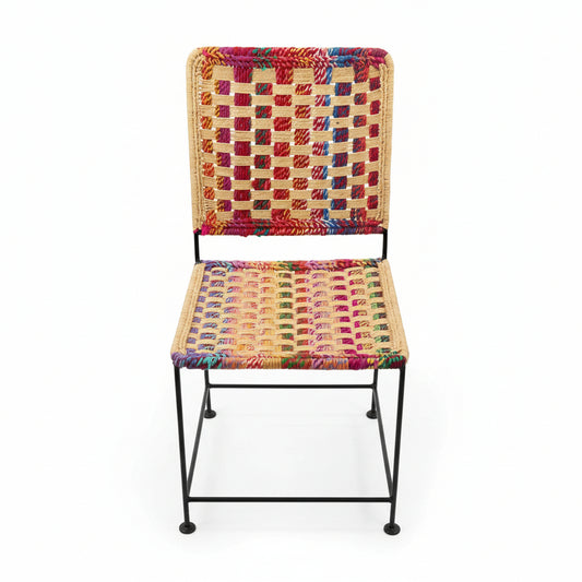 Colorful woven chair with a checkered pattern on a white floor.