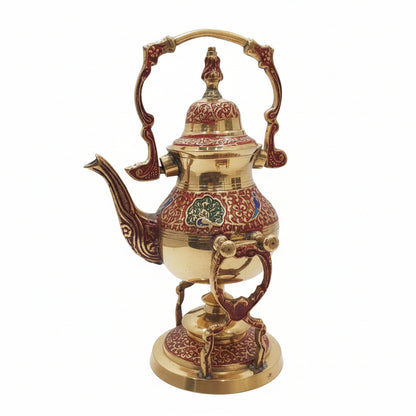 Decorative brass teapot with intricate designs on a white surface and tiled wall background
