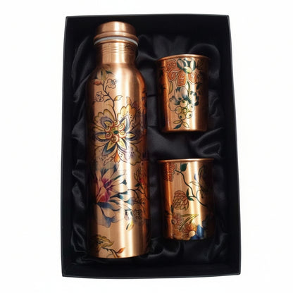 Copper water bottle and cups set in a black box on a white surface