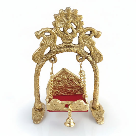 Decorative gold object with intricate designs on a white surface