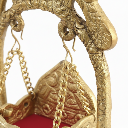 Gold elephant figurine with heart-shaped pendants on a white background