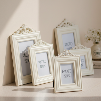 Set of decorative white photo frames on a light surface with a neutral background.