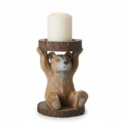 Bear-shaped candle holder with a candle on a wooden surface