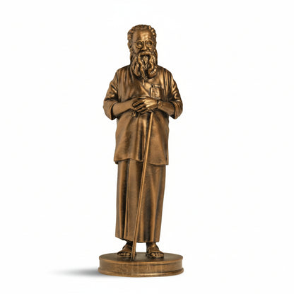 Bronze statue of a man with glasses and a beard on a gray background