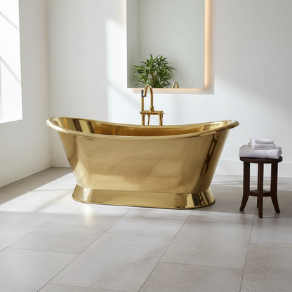 Gold freestanding bathtub in a modern bathroom with a plant and stool.