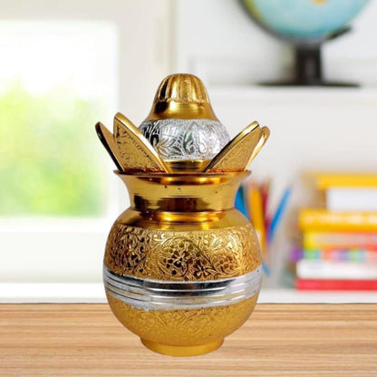 Decorative gold and silver urn on a wooden surface with a blurred background
