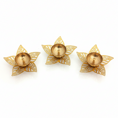 Three gold decorative candle holders on a white background