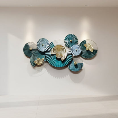 Decorative wall art with circular, fan-like shapes in teal, gold, and blue on a white background.