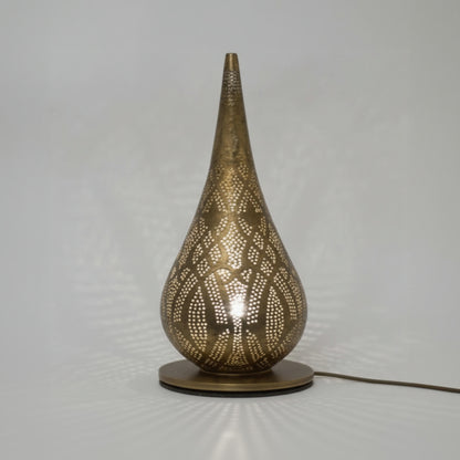 Decorative table lamp with intricate design on a plain background