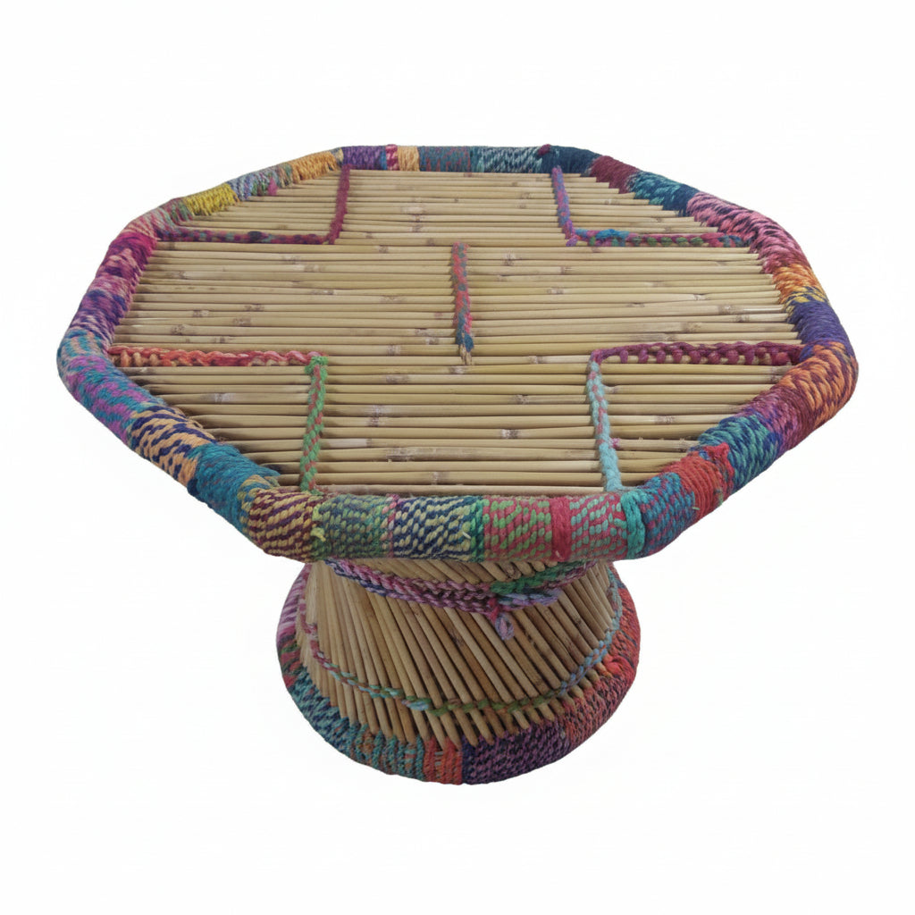 Colorful woven chair on a paved ground