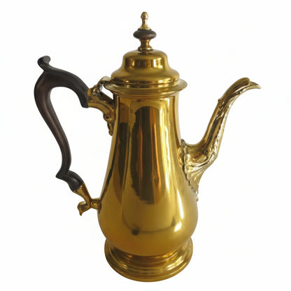 Gold coffee pot with a black handle on a white background