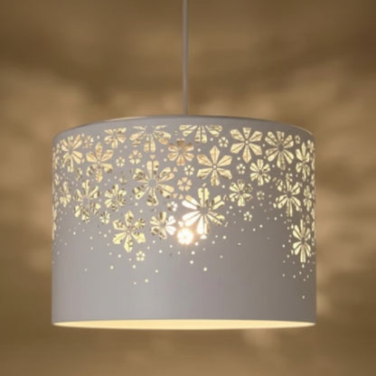 Gray pendant lamp with floral cutout design on a brown background