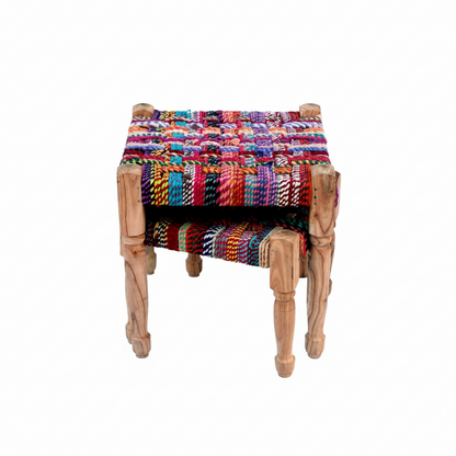 Colorful woven stool with wooden legs on a white background