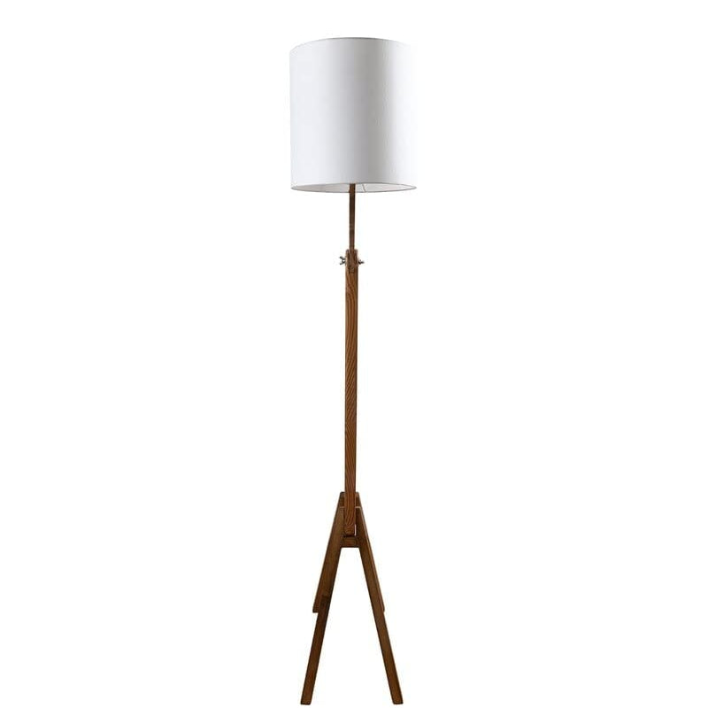 Floor lamp with wooden base and white shade on a white background