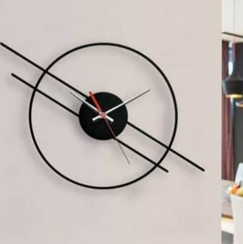 Modern wall clock with black and red design on a light gray background
