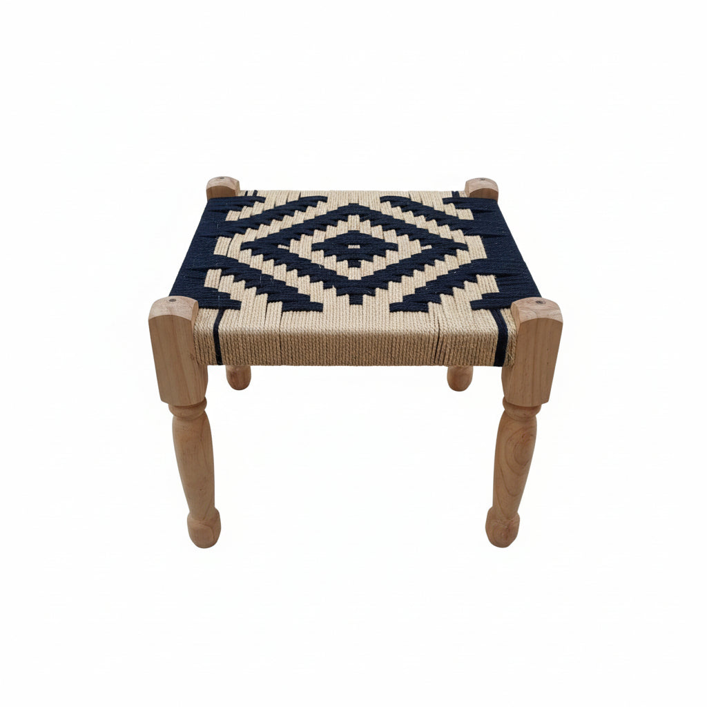 Small stool with woven top and wooden legs on a gray pavement