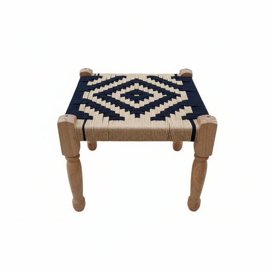 Small stool with woven top and wooden legs on a gray pavement