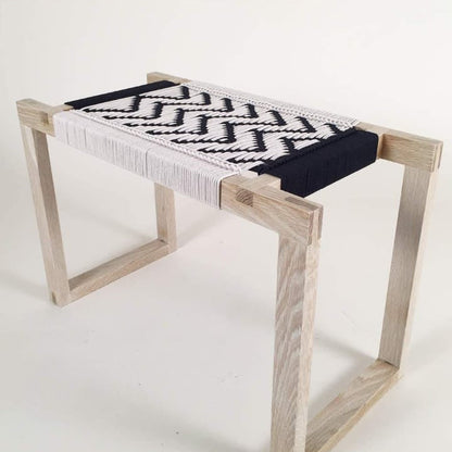 Wooden bench with woven seat and backrest on a white background