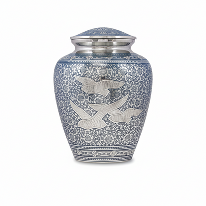 Blue and silver urn with intricate designs on a white background