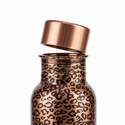 Copper-colored bottle with leopard print pattern on a white background