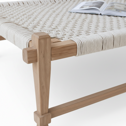 Woven bench with wooden legs on a white background