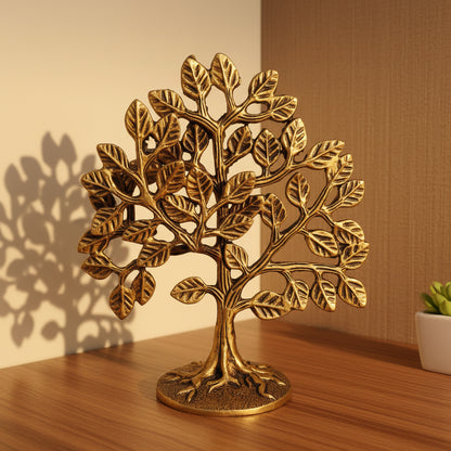 Decorative brass tree on a wooden surface with a white background