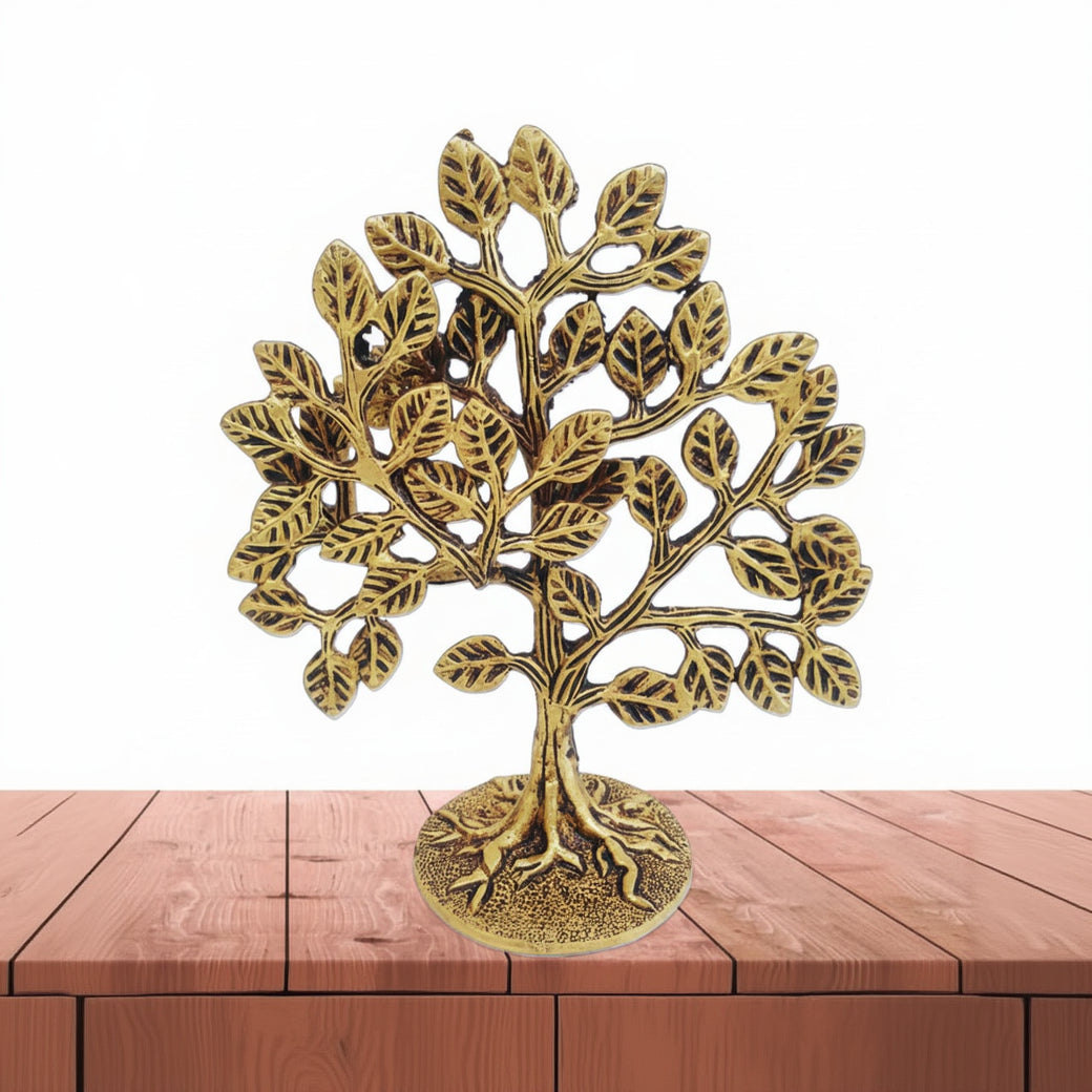 Decorative brass tree on a wooden surface with a white background