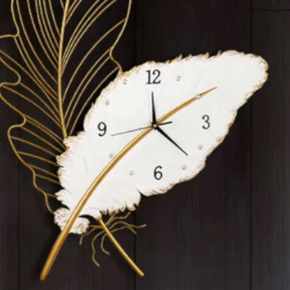 Decorative wall clock shaped like a feather with gold accents on a dark background