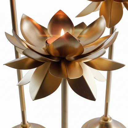 Set of three gold lotus flower candle holders on a white background