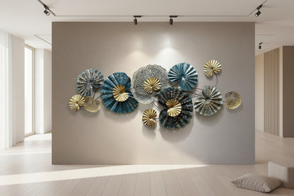 Decorative wall art with metallic, fan-shaped pieces on a plain wall.