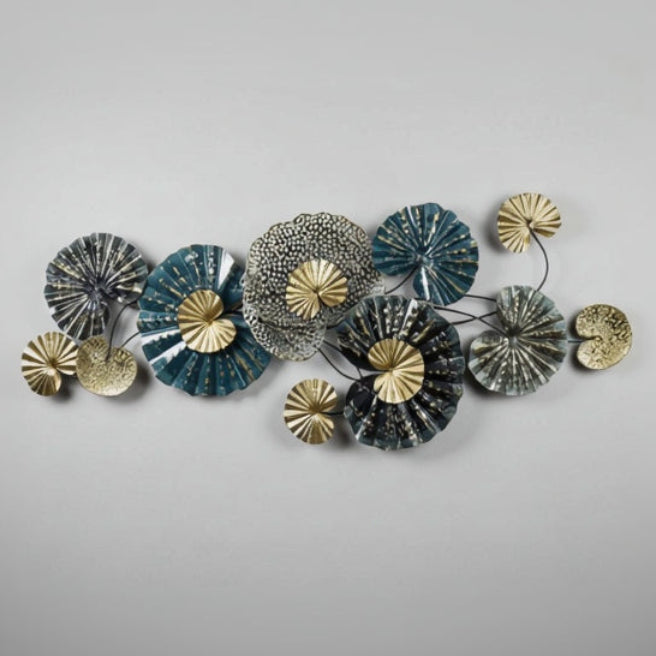 Decorative wall art with circular metal pieces in gold, silver, and blue on a white background