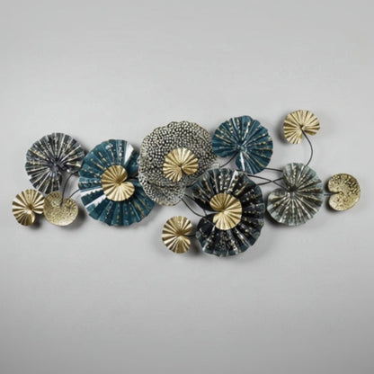 Decorative wall art with circular metal pieces in gold, silver, and blue on a white background