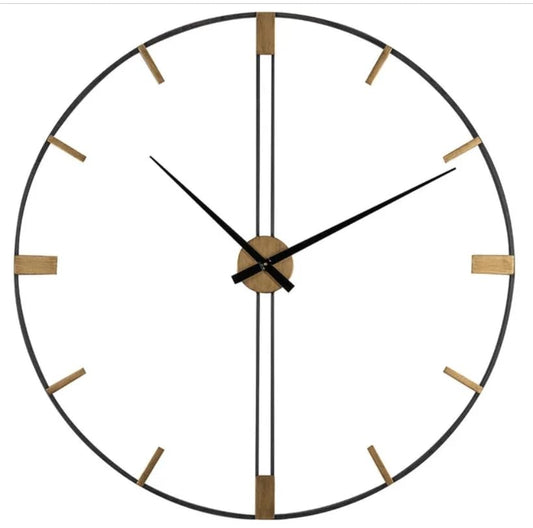 Round wall clock with black frame and gold accents on a white background