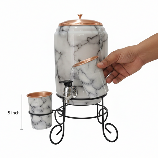 Marble-patterned drink dispenser with cups on a stand, hand holding a cup.