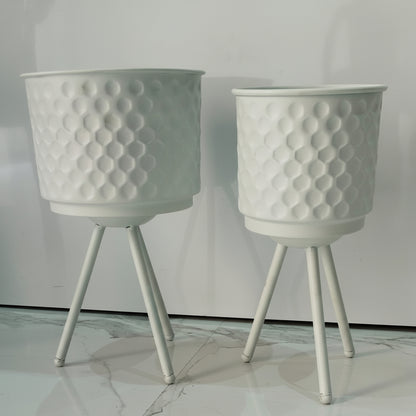 Two white textured planters with legs on a light gray background