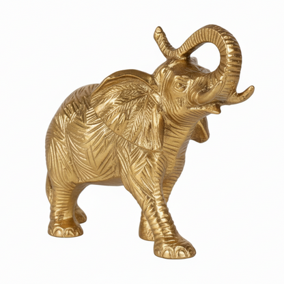 Gold elephant figurine on a white background