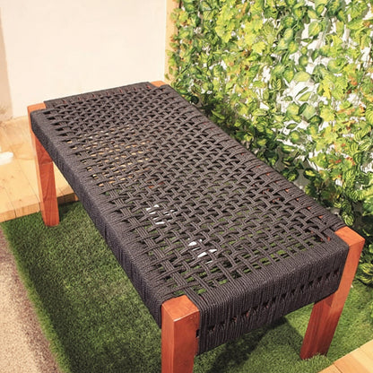 Woven bench with wooden frame on grass