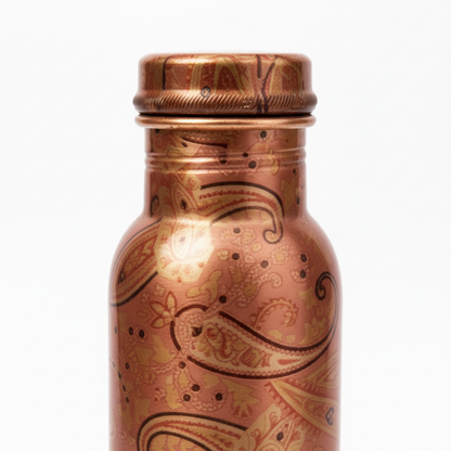 Copper bottle with intricate paisley patterns on a white background