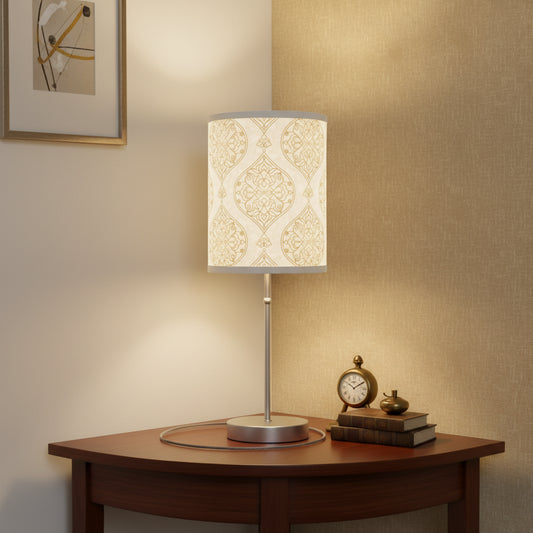 Table lamp with decorative white and gold patterned shade on a white background
