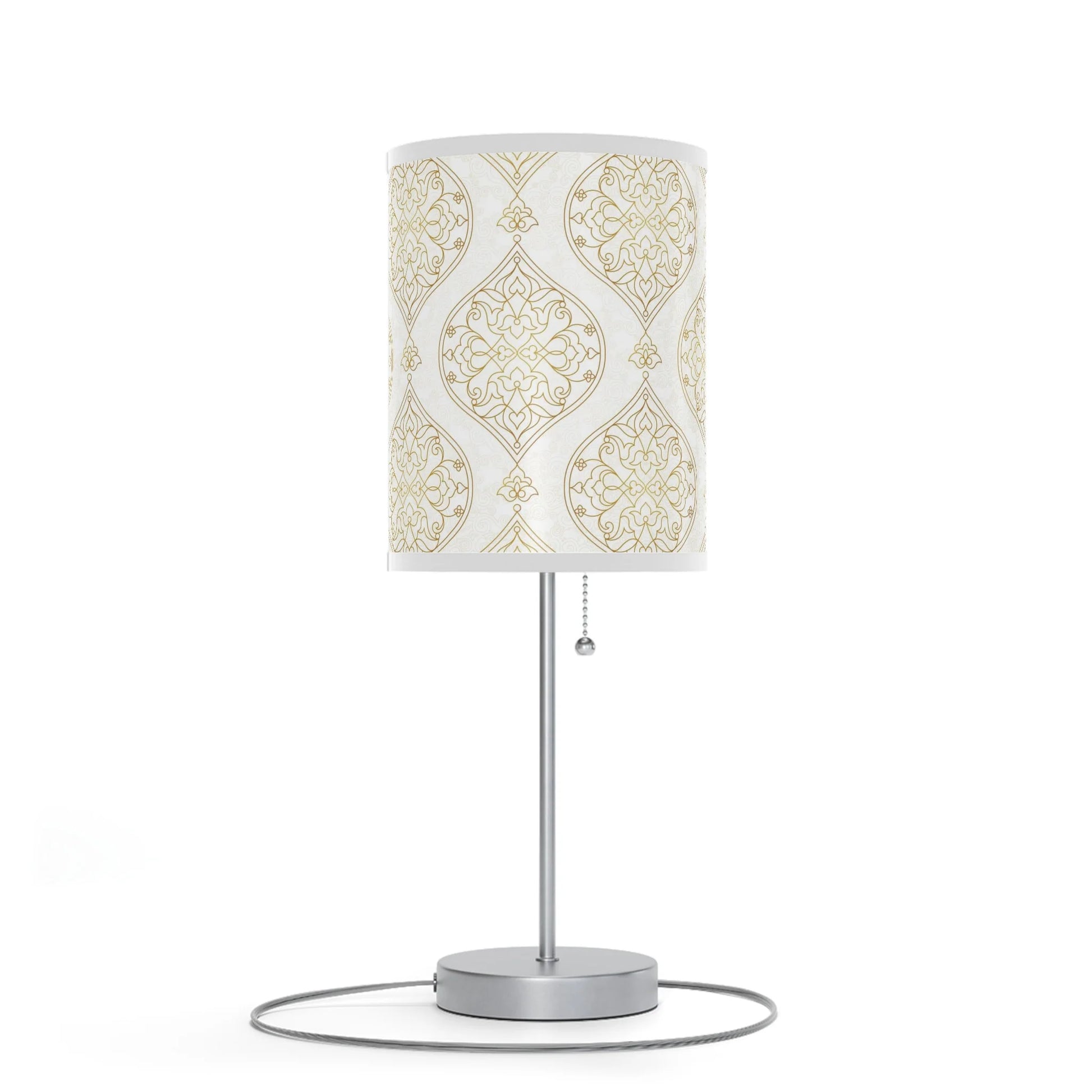 Table lamp with decorative white and gold patterned shade on a white background
