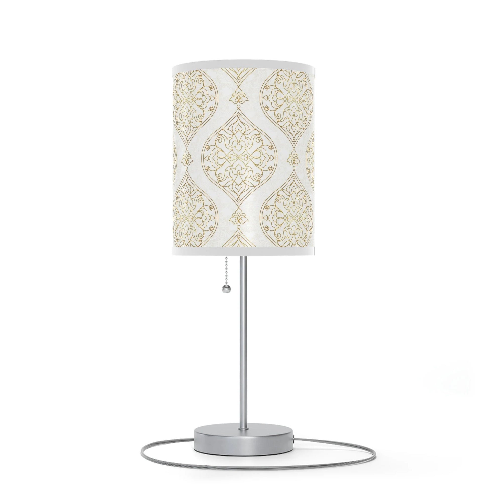 Table lamp with decorative white and gold patterned shade on a white background