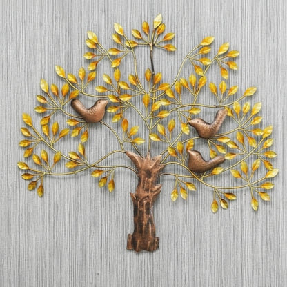 Decorative wall art of a tree with birds and gold leaves on a gray background