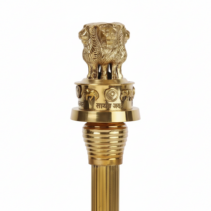 Gold-colored decorative object with a lion emblem on a white background