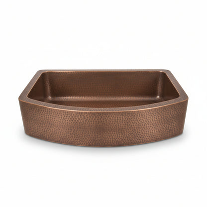 Brown ceramic sink on a wooden surface