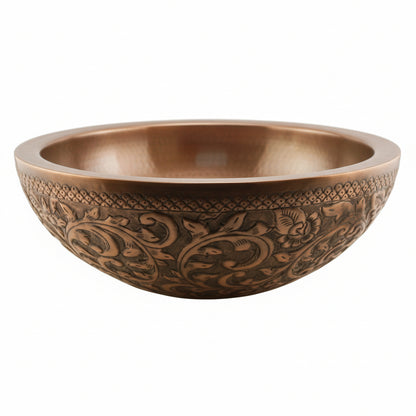 Decorative copper bowl with intricate patterns on a white background