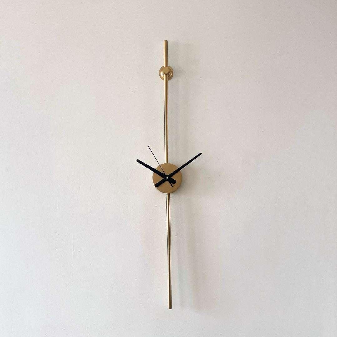Modern wall clock with gold long hand on a white background