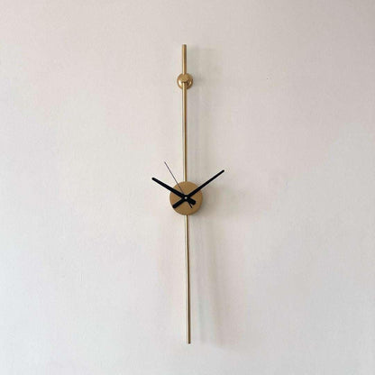 Modern wall clock with gold long hand on a white background
