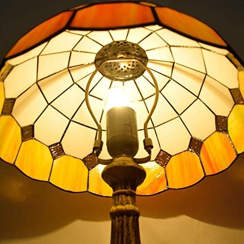 Stained glass lamp with warm colors on a dark background